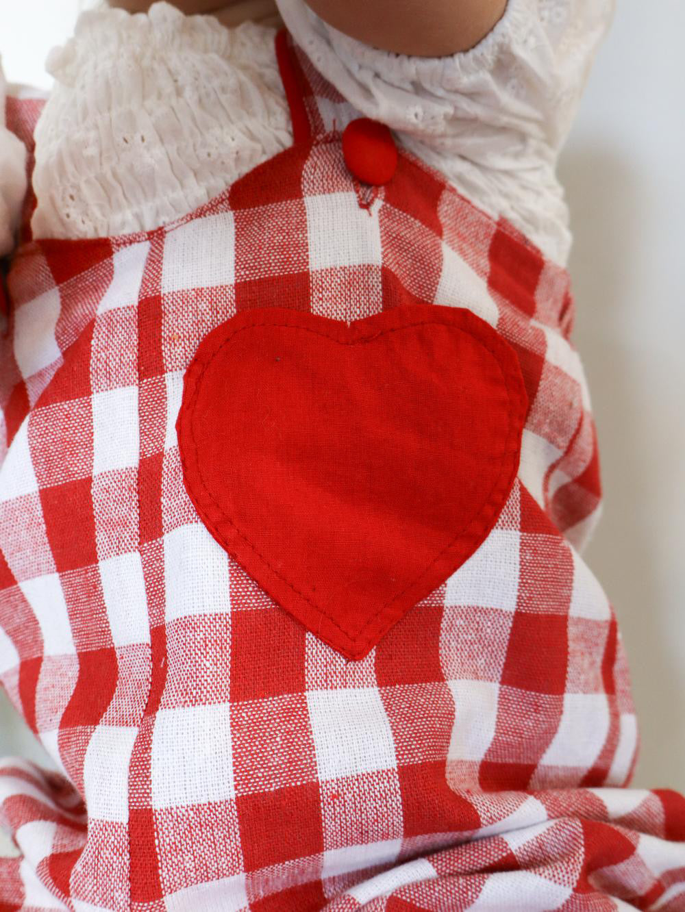 Red checkered outfit with a heart design on a plain background