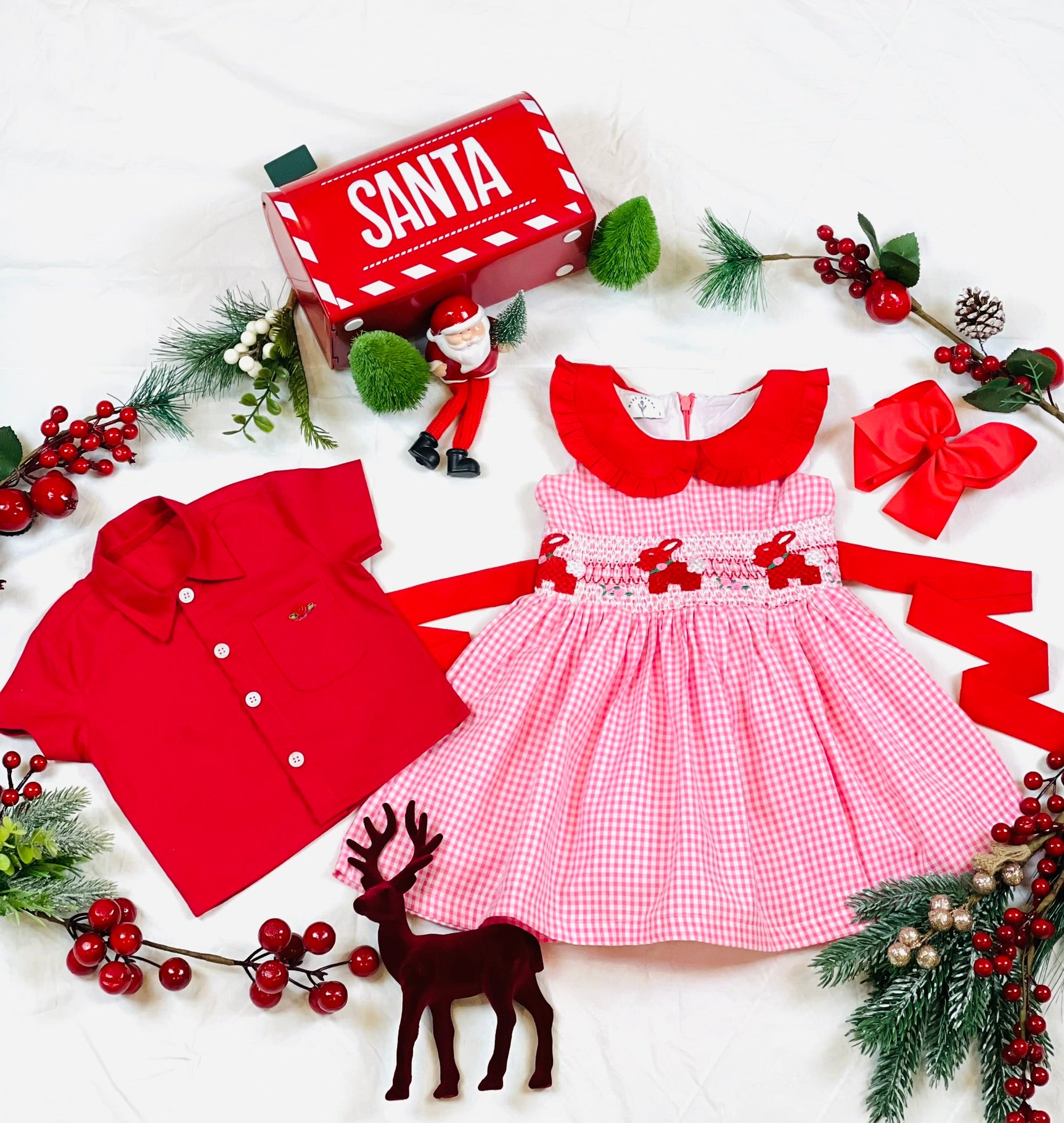 Red collar with frills, pink and white gingham dress with red hand-smocked bunnies and roses in the middle of the dress with a contrasting red rear bow stash and matching this dress is a red cotton shirt with red satin rose on the pocket with contrasting white buttons